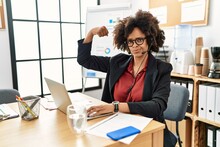 African American Woman With Afro Hair Working At The Office Wearing Operator Headset Strong Person Showing Arm Muscle, Confident And Proud Of Power