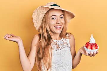 Canvas Print - Young caucasian woman wearing summer style holding ice cream screaming proud, celebrating victory and success very excited with raised arm