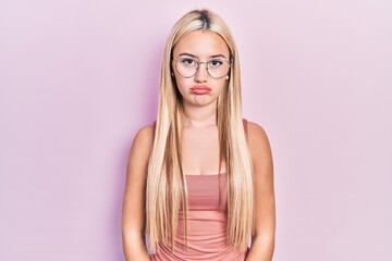 Wall Mural - Young blonde girl wearing casual clothes depressed and worry for distress, crying angry and afraid. sad expression.