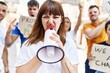 © Krakenimages.com - Group of young activists protesting holding banner and using megaphone at the city.