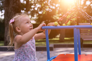 Wall Mural - Smiling little child on the playground. Real people