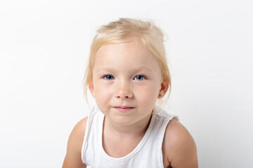 Wall Mural - Beautiful pensive blonde girl on a light background in the studio