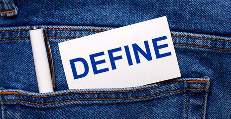 The back pocket of blue jeans contains a white pen and a white card with the text DEFINE