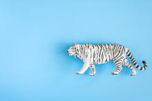 The Tiger, Symbol Of 2022 Year. Plastic White Toy Figure Tiger On A Blue Background. Top View. Space For Text
