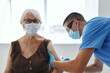 © SHOTPRIME STUDIO - elderly woman and doctor hospital vaccination covid passport