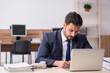 © Elnur - Young male employee sitting at workplace