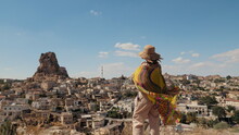 Woman Tourist Wrapped In A Shawl Looks At A Beautiful Old Town In Turkey With A Fortress In The Mountain In The Middle