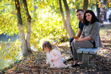 Leaf fall in the park. Children for a walk in the autumn park. Family. Fall. Happiness.