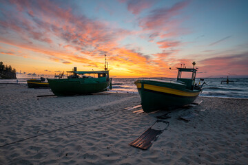 Wall Mural - fishing boats on the sea beach during the spectacular sunrise