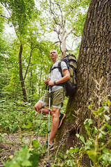 Relaxed young man hiking alone in nature