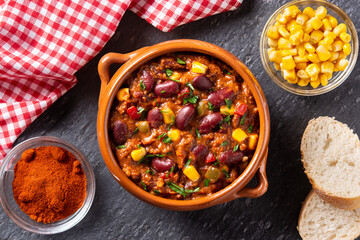 Wall Mural - Traditional mexican tex mex chili con carne in a bowl on black background