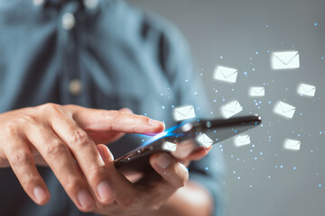 Aufkleber - Man hand using smart phone with email icon flying abstract. Technology business and freelance concept.