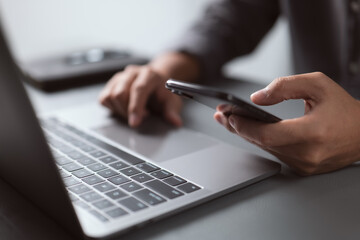 Aufkleber - Businessman working with devices. Student using laptop computer and mobile smart phone, business concept