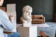 © Drobot Dean - Young white student drawing plaster bust during class in art school