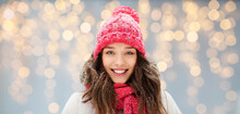People, Season And Christmas Concept - Portrait Of Happy Smiling Teenage Girl Or Young Woman In Winter Over Festive Lights Background