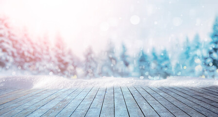 Wall Mural - winter festive christmas background - surface of wooden planks with snow cap on light blurred backgr