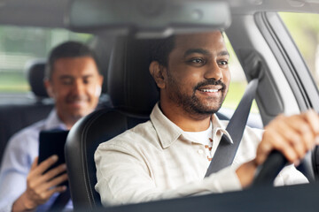 transportation, vehicle and people concept - happy smiling indian male driver driving car with passenger