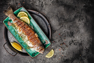 Canvas Print - Grilled trout fish with lemon. banner, menu, recipe place for text, top view