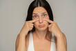 © vladimirfloyd - Funny Unhappy Woman Pressing  Her Lower Eyelids With Her Fingers