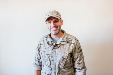 Wall Mural - Caucasian man in camouflaged army uniform crossing arms