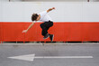 © cherryandbees - skateboarder does tricks outdoorin city