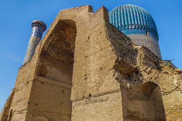 Wall Mural - Massive arch of the Gur Emir mausoleum in Samarkand, Uzbekistan. The patterned dome and minaret are visible behind