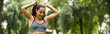 © LIGHTFIELD STUDIOS - happy athletic woman in crop top adjusting ponytail in green park, banner