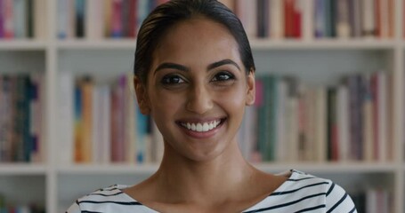 Indian student researcher smiling portrait in library education setting