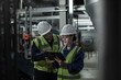 © ReeldealHD images - Male engineer and female engineer working together in an industrial plant room