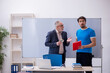 © Elnur - Old male teacher and young male student in front of whiteboard