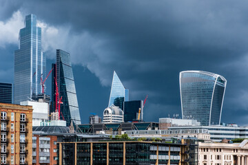 City of London busines district Shiny Skyscrapers set against a dramatic stormy sky.