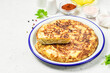 © irina - Spanish tortilla, potato onion omelette on light background. Space for text.