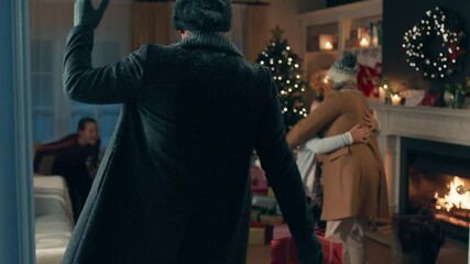 grandparents visiting for christmas eve hugging family enjoying festive holiday celebration on winte
