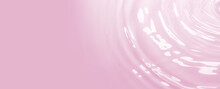 Drops On Pink Water Background Under Sunlight. Top View, Flat Lay. Banner Copyspace For Text For Cosmetics And Relaxation Concept