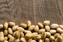 Border Of Salted, Roasted Green Pistachio Nuts Snack On Wood Background, Healthy Food Snack, Copy Space