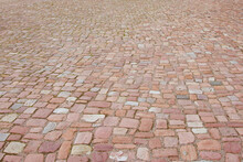 Old cobblestone pavement. Stone vintage paved road in perspective