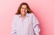 © Asier - Young caucasian woman isolated on pink background  laughs and closes eyes, feels relaxed and happy.