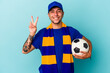 © Asier - Young soccer fan man holding a ball isolated on blue background  showing number two with fingers.