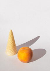 Wall Mural - orange peach and ice cream cone on a white background with soft shadows.sunny day idea.fresh food design