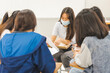 © EduLife Photos - Group asian university students wear protective face mask discuss project in the classroom