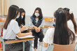 © EduLife Photos - Group asian university students wear protective face mask discuss project in the classroom