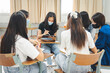 © EduLife Photos - Group asian university students wear protective face mask discuss project in the classroom