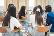 © EduLife Photos - Group asian university students wear protective face mask discuss project in the classroom