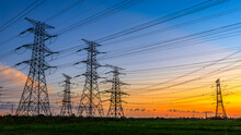 High Voltage Power Tower Industrial Landscape At Sunrise,urban Power Transmission Lines.