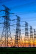 © ABCDstock - High voltage power tower industrial landscape at sunrise,urban power transmission lines.
