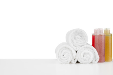 Wall Mural - Composition of cosmetic bottles and towels isolated on white