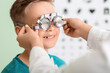 © Pixel-Shot - Little boy undergoing eye test in clinic