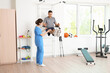 © Pixel-Shot - Female physiotherapist working with patient in rehabilitation center