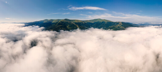 Sticker - Aerial panorama of a mountain range above the clouds