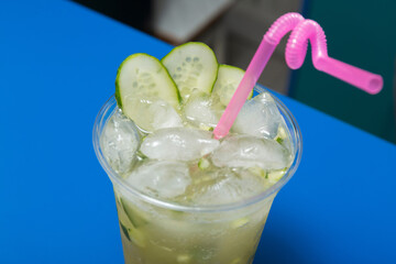 Wall Mural - Cocktail with cucumber, lime and ice on the bar